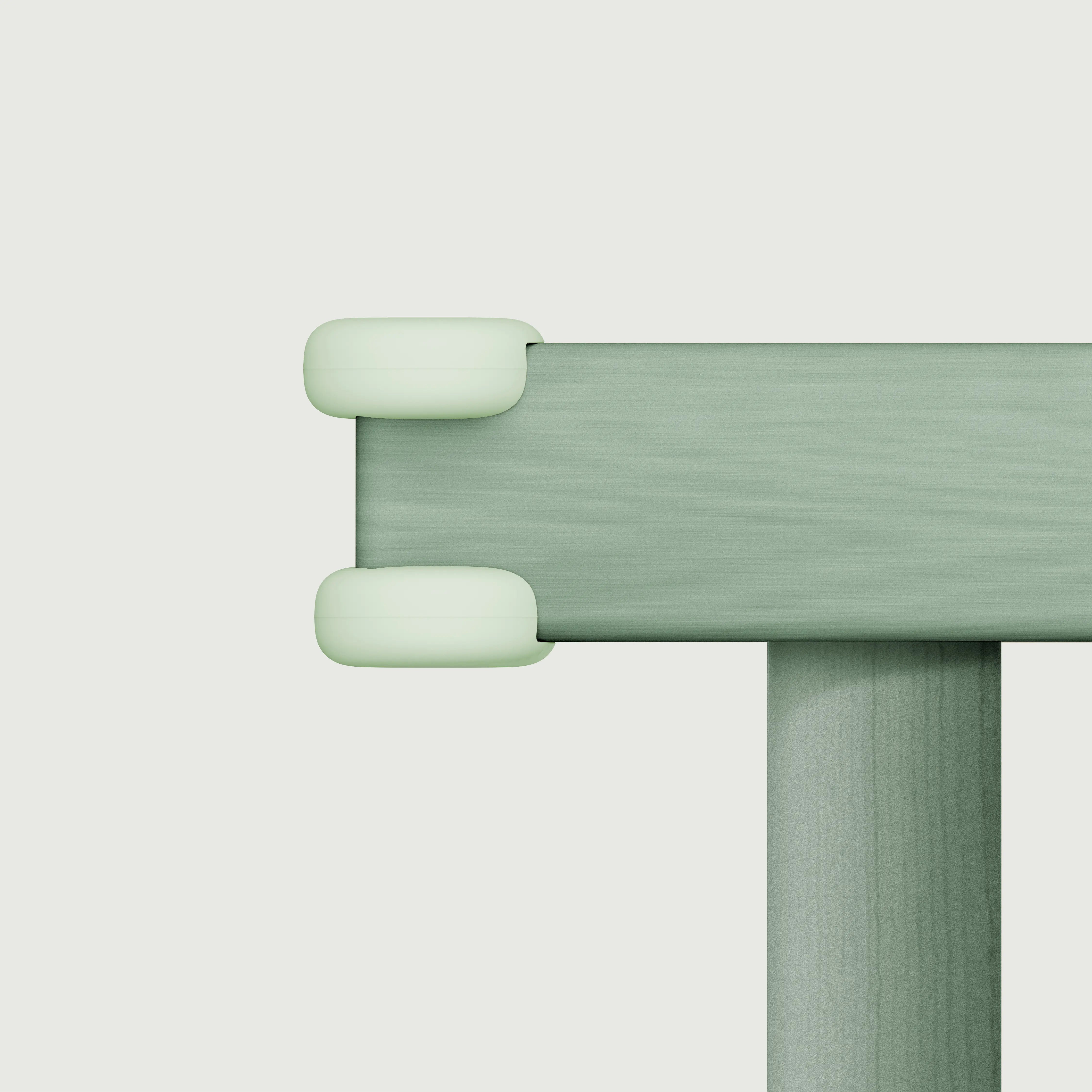 Pom Corner Protector — soft silicone babyproofing guard for sharp furniture corners in aloe on a table