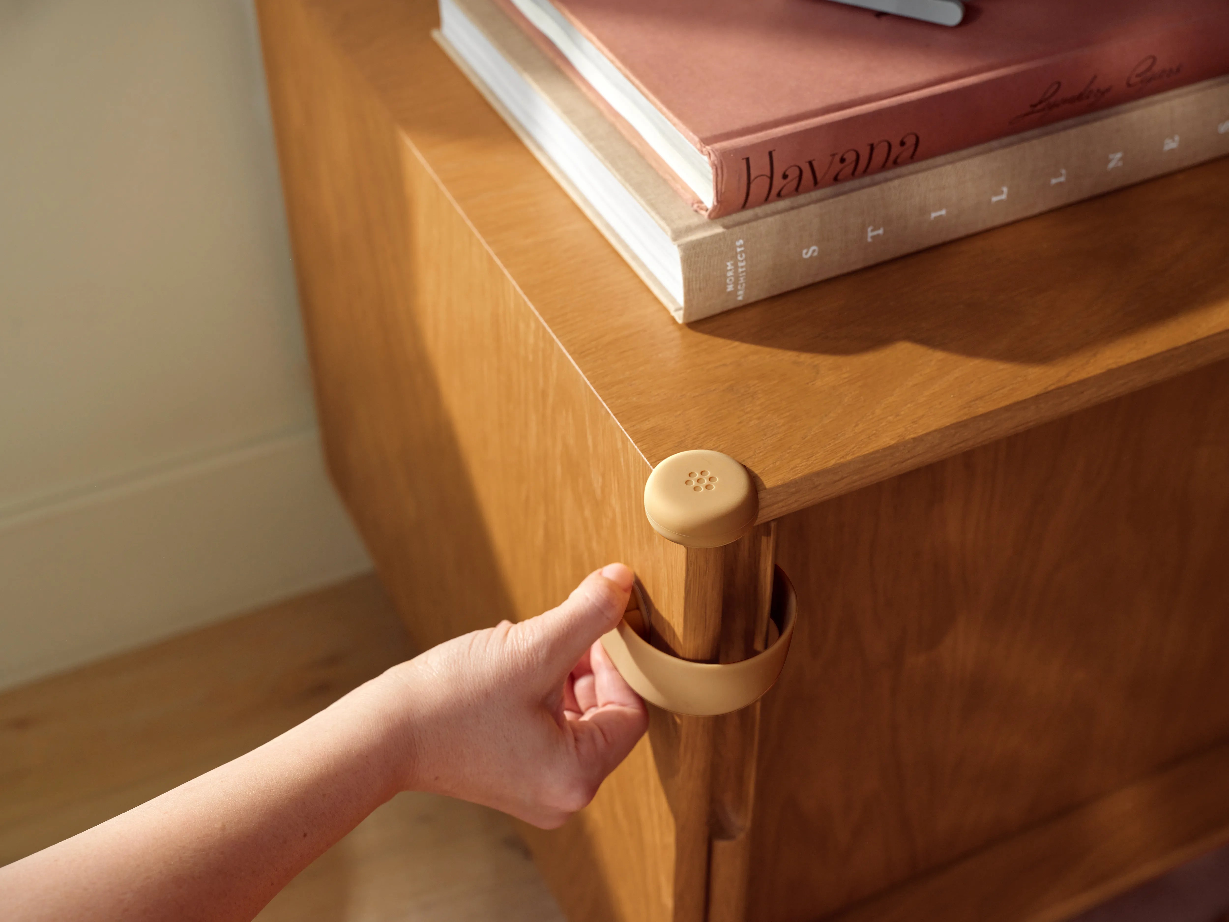 Pom Corner Protector — soft silicone babyproofing guard for sharp furniture corners in the living room