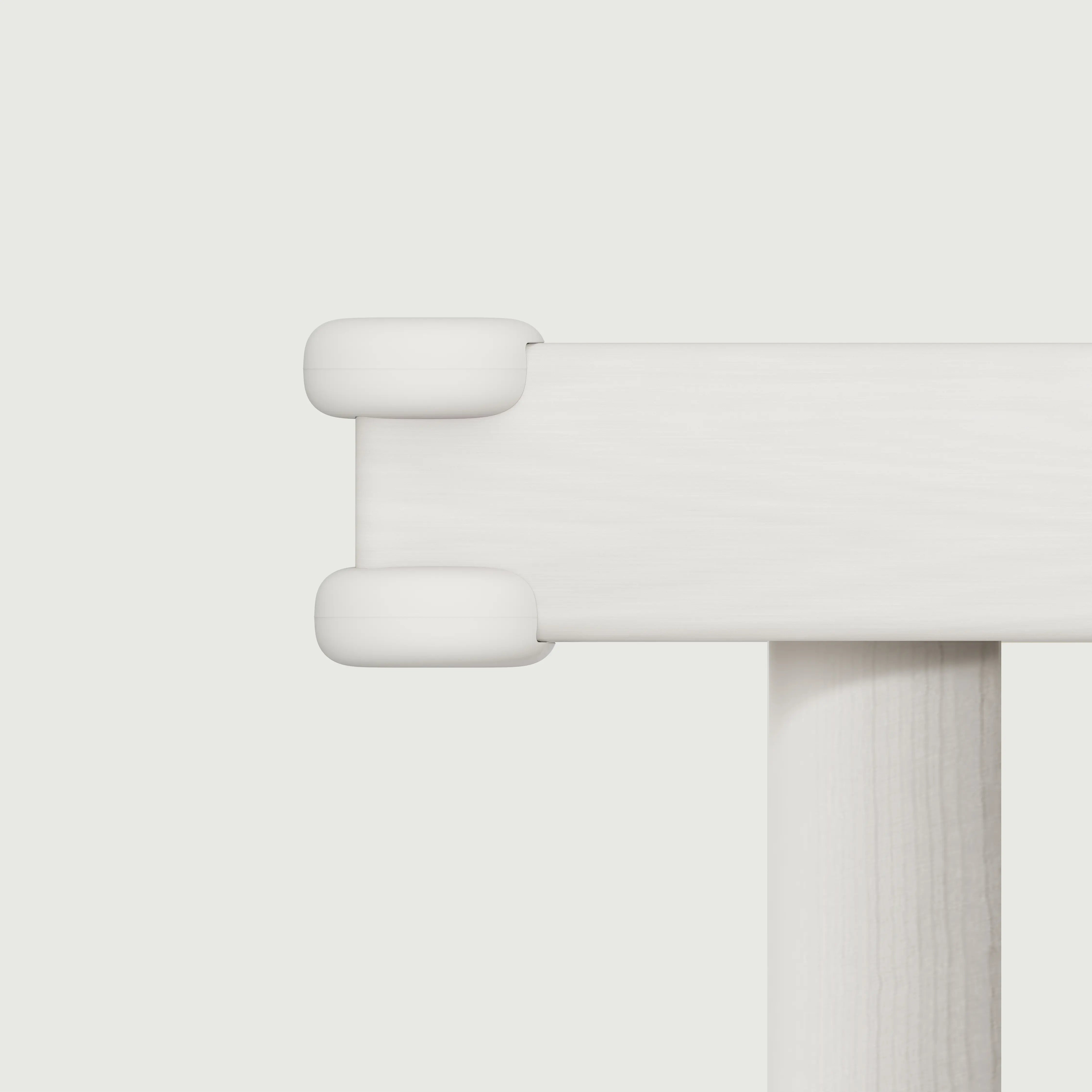 Pom Corner Protector — soft silicone babyproofing guard for sharp furniture corners on the dining table in white