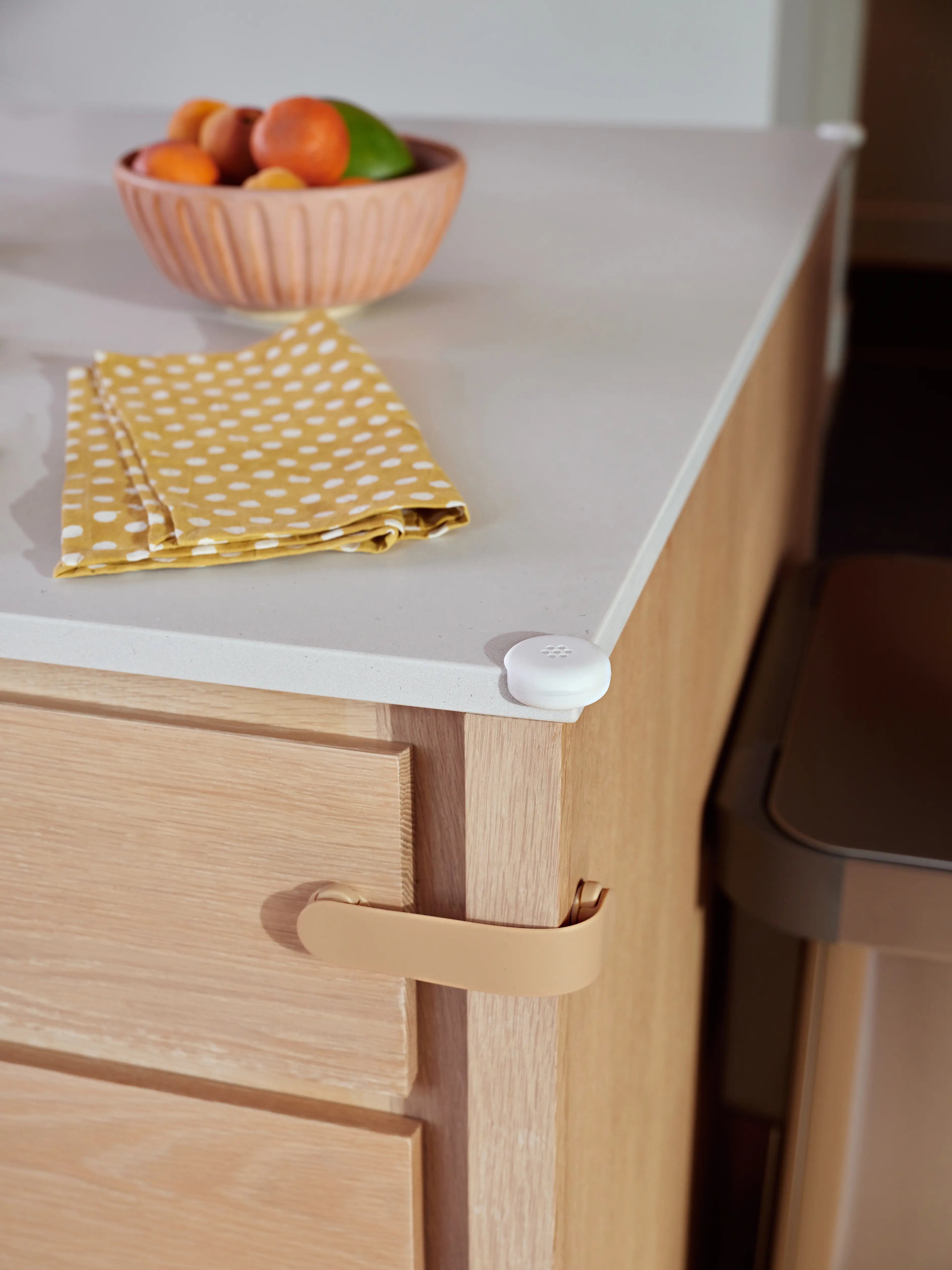 Pom Corner Protector — soft silicone babyproofing guard for sharp furniture corners on the kitchen counter