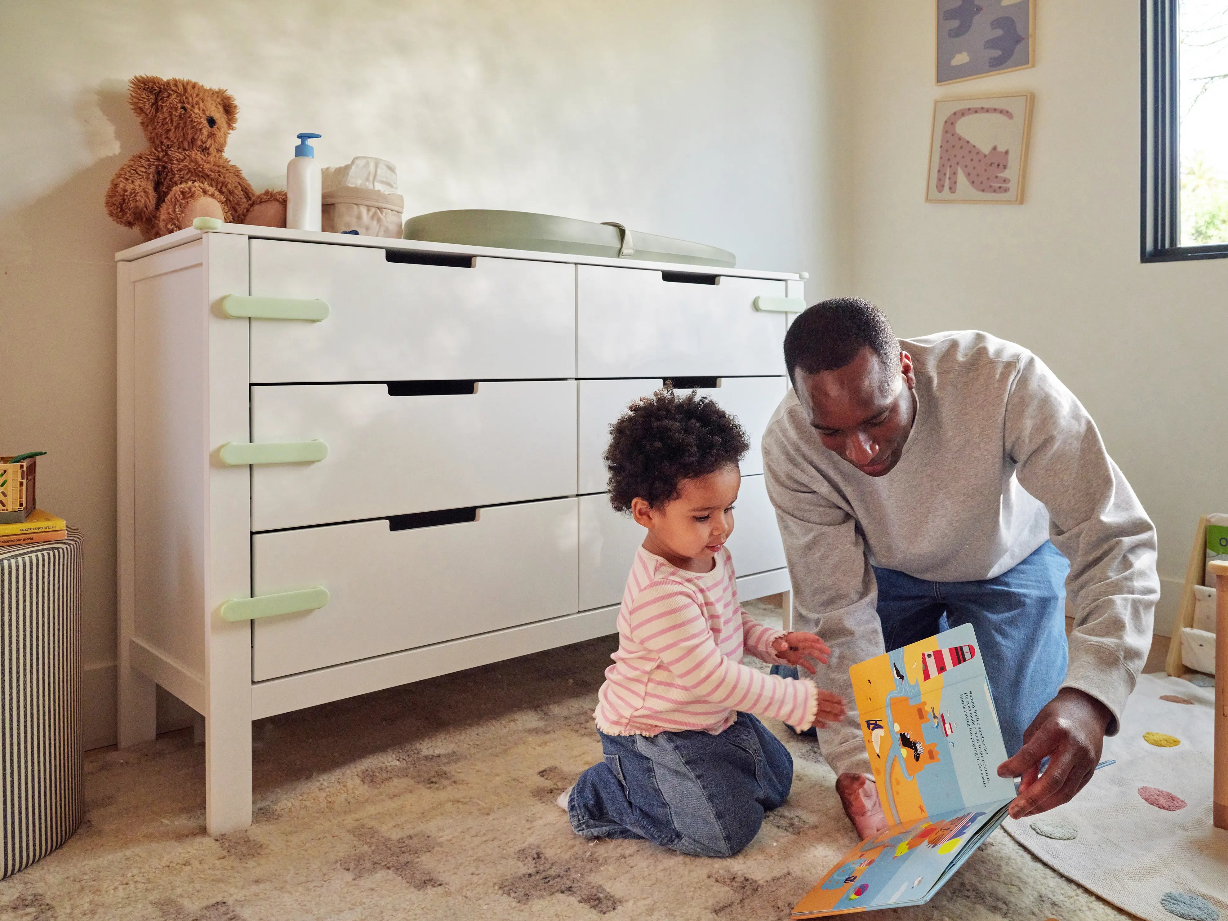 Pom Corner Protector — soft silicone babyproofing guard for sharp furniture corners on a dresser in a nursery