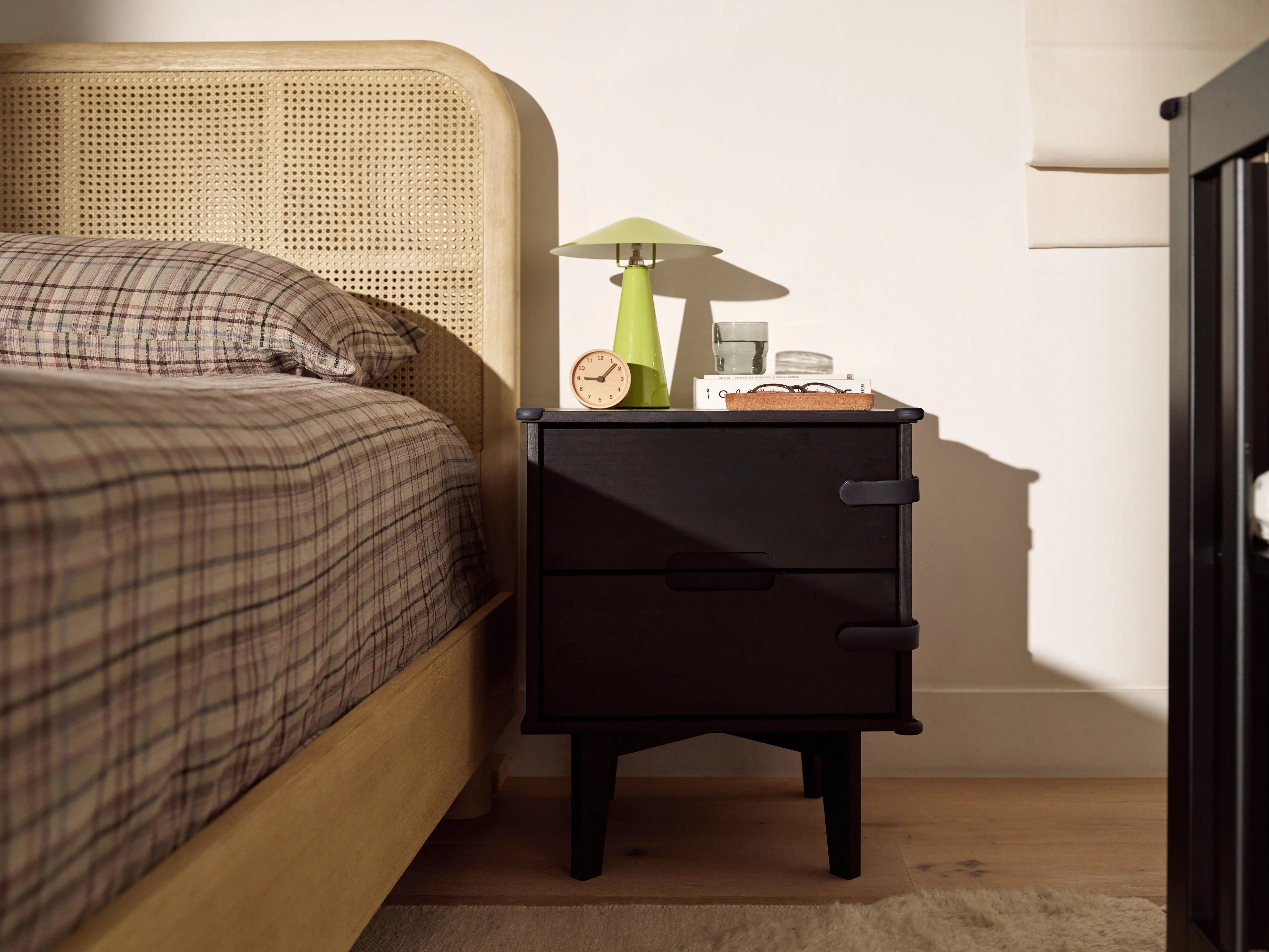 Pom Corner Protector — soft silicone babyproofing guard for sharp furniture corners on a bedside table in the bedroom